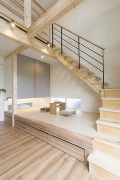 an empty room with wooden stairs and white walls