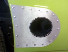 the front end of a green vehicle with metal rivets