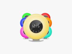 an alarm clock with multicolored balls around it