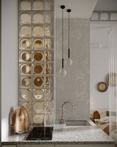 a modern kitchen with marble counter tops and stainless steel faucets in the corner