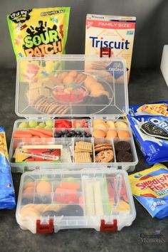 an open lunch box filled with snacks and other items to make it look like they are on the table