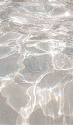 the water is crystal clear and there are ripples on the sand in it's surface