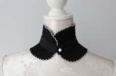 Pleated collar necklace in black color with white tips. Fastened with a button and a loop. width - 9 cm | 3.6 in length - 39 cm | 15.5 in Collar gives a chic touch to simple dresses and blouses. One size. Handmade item. Wonderful gift for women or female friends. Elegant White Top With Detachable Collar, Chic White Top With Detachable Collar, Chic Adjustable Collar Necklace, Black Collar Choker, Elegant White Lace Collar, White Fitted Detachable Collar, High Collar Shirts, Pleated Collar, White Tips