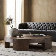 a living room with a couch, coffee table and rug