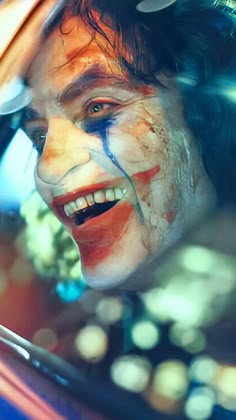 a man with his face painted as the joker