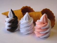 three ice cream cones sitting next to each other on top of a white countertop