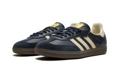 The adidas Samba OG “Night Navy/Cream White” is a navy based colorway of the retro indoor soccer shoe.  Designed to be worn casually, the Samba OG in the “Navy/Cream White” colorway has a Night Navy leather upper with tonal suede on the toe and a Cream White leather overlay on the heel tab.  Cream White leather Three Stripes and gold “Samba” branding can be seen on the side.  Classic “Samba” detailing is found on the tongue.  A dark brown rubber sole completes the iconic sneaker.  Release date: Adidas Navy Sneakers With Rubber Sole, 70s Converse, Iconic Sneakers, Packaging Accessories, Nike X Travis Scott, Ugg Ultra Mini, Converse Run Star Hike, Converse Run, Low Air Jordan 1