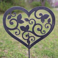 a heart shaped iron decoration in the grass