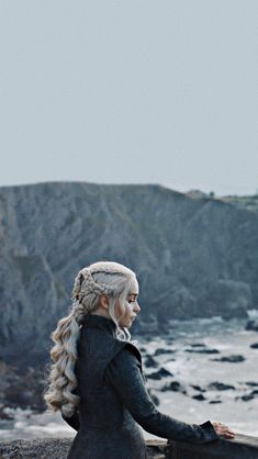 game of thrones'daeneress starke sitting on the rocks by the ocean