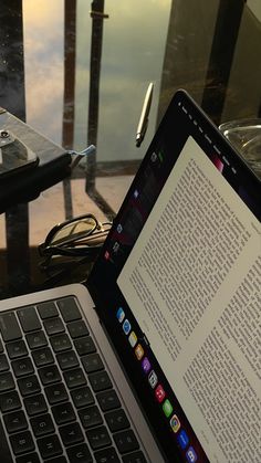 an open laptop computer sitting on top of a table