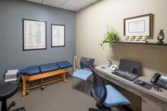 an office with blue chairs and a desk