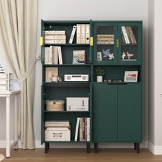 a green bookcase with many books on it