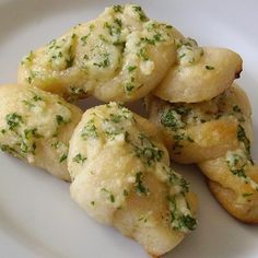 some food is on a white plate with green sprinkles and parsley