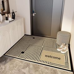 a welcome mat is on the floor in front of a door with an entrance mat