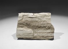 a piece of stone sitting on top of a white table