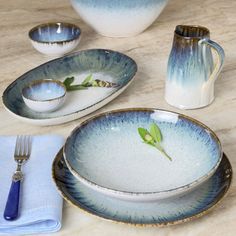 a table set with blue and white dishes