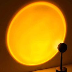 a light that is sitting on top of a table next to a lamp in the shape of a sun