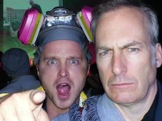 two men with headphones on their heads taking a selfie in front of the camera