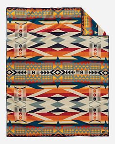 an orange and blue blanket with native designs on it's sides, in front of a white background