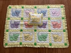 a quilted placemat with teddy bears on it and a pillow in the middle