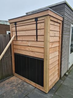 a small wooden building sitting on top of a sidewalk