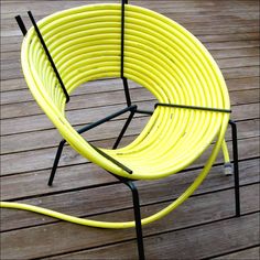 a yellow chair sitting on top of a wooden floor next to a fire hydrant