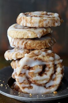 a stack of cinnamon rolls sitting on top of a metal plate