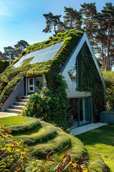 a house covered in green plants with stairs leading up to the roof and side walls