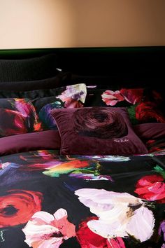 an image of a bed with flowers on the comforter and pillow cases in it