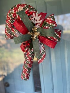 a christmas wreath hanging on the front door