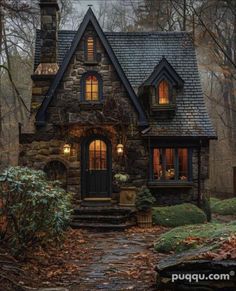 a stone house in the woods at night