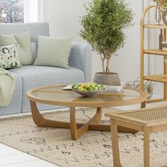 a living room scene with focus on the coffee table and fruit bowl in the center