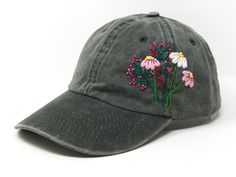 a gray hat with flowers embroidered on it