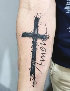 a man with a cross tattoo on his arm and the word mom written in black ink