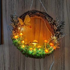 a wreath with fairy lights and mushrooms on it