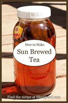 a jar filled with sun - dried tea sitting on top of a wooden table