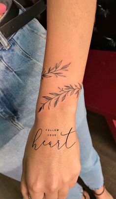 a woman's wrist with the words, follow your heart tattooed on her arm