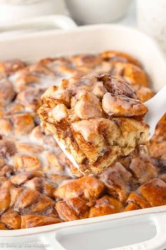 a spoonful of cinnamon roll casserole being lifted from a dish