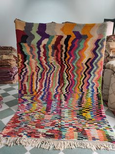 a multicolored blanket sitting on top of a checkered floor