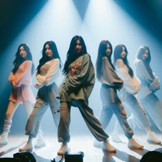 a group of women standing on top of a stage