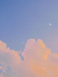 an airplane is flying in the sky with clouds and a half moon behind it at dusk