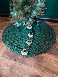 a small christmas tree sits on top of a green mat