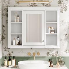 a white sink sitting under a bathroom mirror next to a wall mounted cabinet with shelves