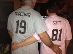 two men in matching shirts standing next to each other