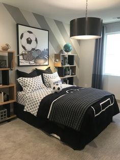 a bedroom decorated in black and white with a soccer theme