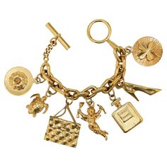 Condition : very good Made in France Material : 24K gold plated metal Color : golden Measurements : maximum wrist width 19 cm Stamp : yes Year : vintage Gold finish metal Details : Chanel charms with handbags, n°5 perfume bottles... Advantage Valois Vintage Paris : comes in its original CHANEL box Luxury Silver Vintage Charm, Luxury Gold Plated Charm Bracelet Gift, Luxury Metal Jubilee Charm Bracelet, Luxury Gold Bracelet With Dangling Charms, Luxury Classic Charm Bracelet With Polished Finish, Cheap Vintage Gold Charm Bracelet, Luxury Vintage Engraved Charm Bracelet, Luxury Heirloom Style Bracelets With Vintage Charm, Luxury Yellow Gold Chain Charm Bracelet