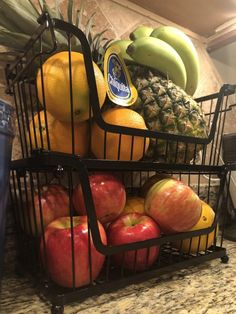 two baskets filled with fruit sitting on top of a counter