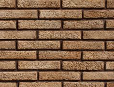 a brown brick wall with no mortar or mortars on the top and bottom part