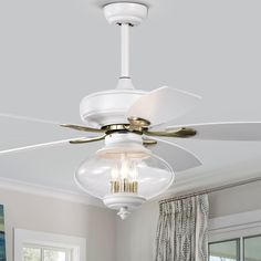 a white ceiling fan with three lights in a room