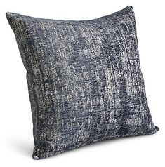 the blue and white pillow is made from linen, which has been dyed in different shades